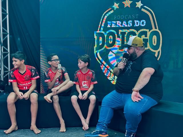 Gravação do podcast “Feras do Jogo” com apresentador e crianças em painel de cenário de LED, ativação de marca produzida pela GDX Brasil.